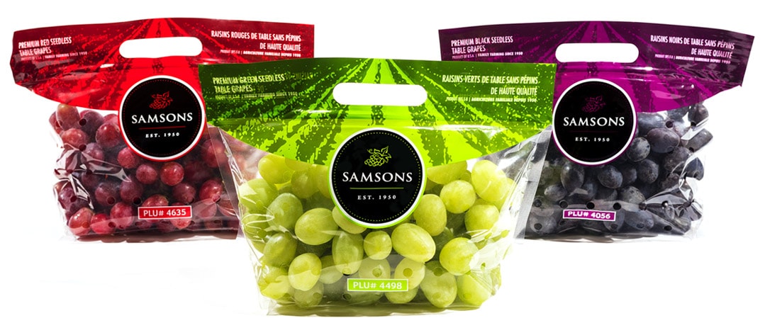 Green, red and black grape packages.
