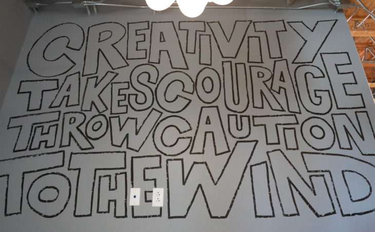 "Creativity takes courage, throw caution to the wind" office mural