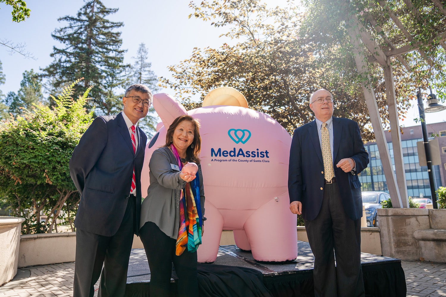 Photo of Supervisors Simitian and Lee, and Hung Wei, the Mayor of Cupertino, posing in front of Piggy Bank.